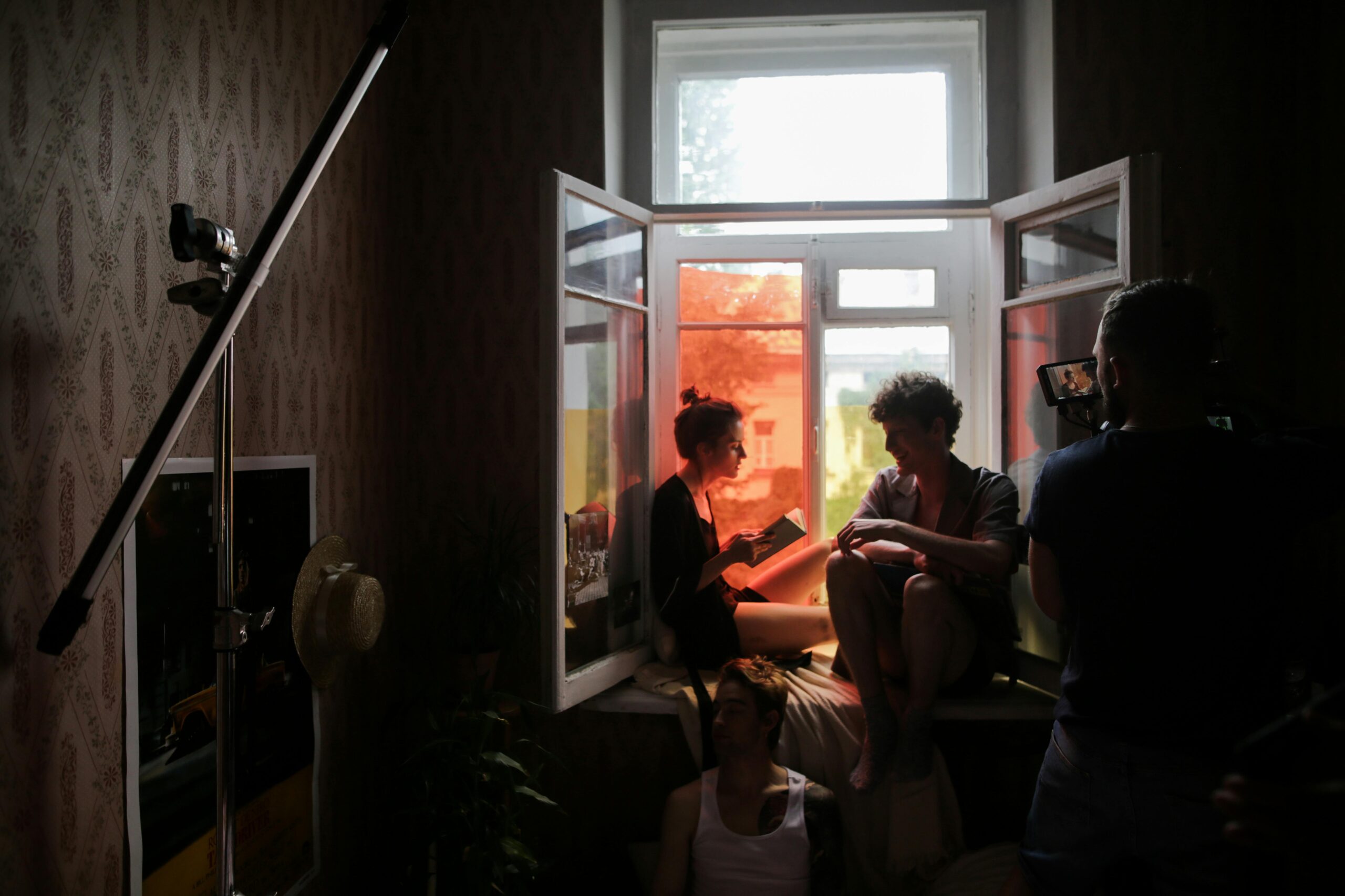 A behind-the-scenes look at a creative film shoot with models in natural light.